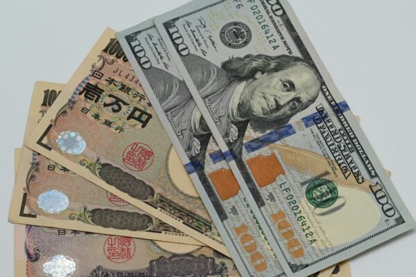 Close-up image of US dollars and Japanese yen notes, representing currency exchange concept.