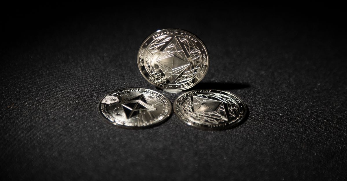 Close-up of three Ethereum coins on a dark background, showcasing digital currency themes.