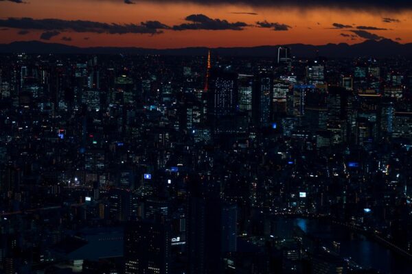 A stunning twilight view of Tokyo's vibrant cityscape featuring iconic landmarks and city lights.