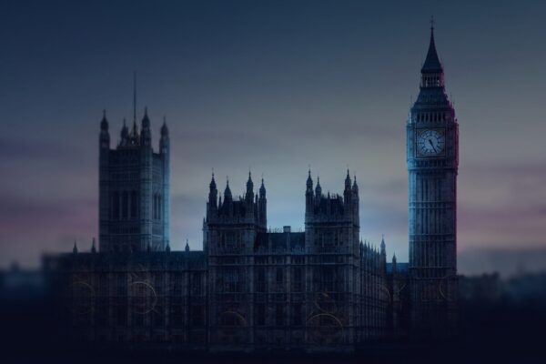 Ilustración: the Houses of Parliament silhouetted against a dusk sky. Ilustración generada con IA.