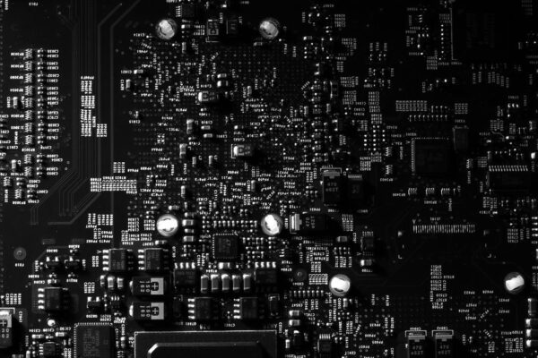 Detailed black and white photo of a circuit board showing intricate components, perfect for tech projects.