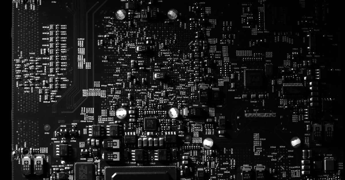 Detailed black and white photo of a circuit board showing intricate components, perfect for tech projects.