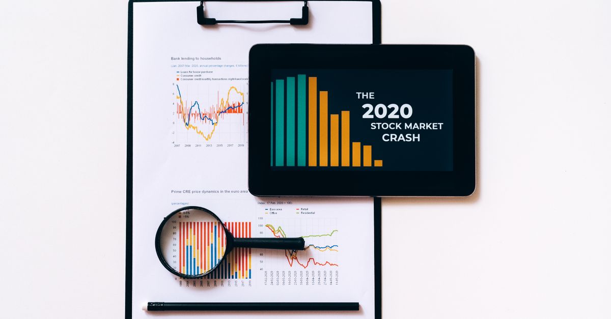 Tablet and clipboard with charts illustrating the 2020 stock market crash.