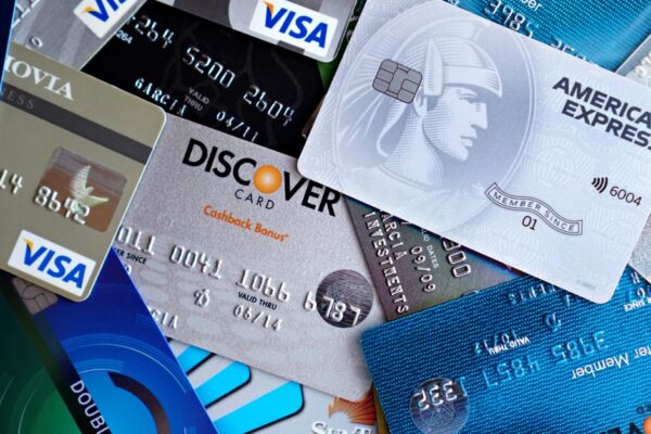 Close-up image of various credit cards including Visa, Mastercard, and American Express.