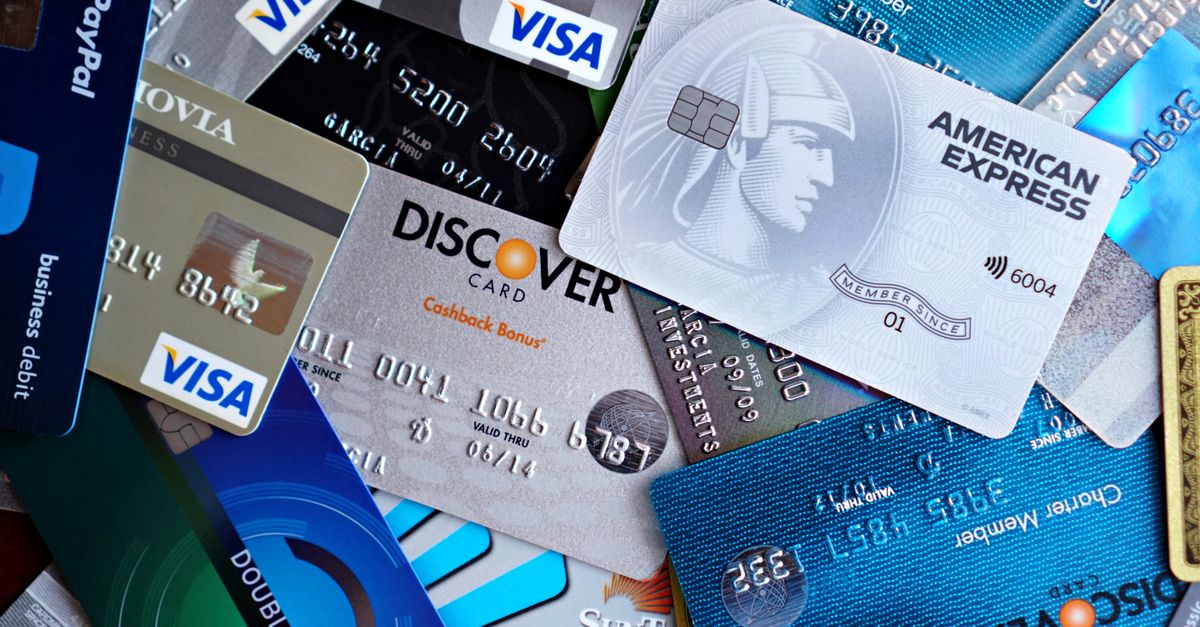 Close-up image of various credit cards including Visa, Mastercard, and American Express.