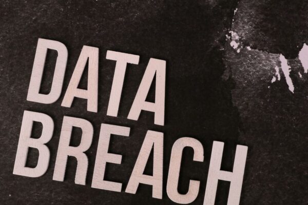 A conceptual image highlighting the issue of data breaches, featuring bold text on a textured background.