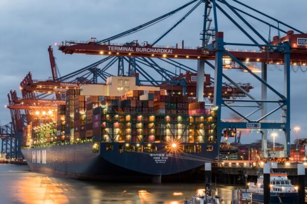 Container ships moored at Terminal Burchardkai in Hamburg, Germany during evening hours.