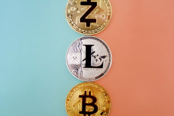 Colorful display of Zcash, Litecoin, and Bitcoin coins on gradient background.